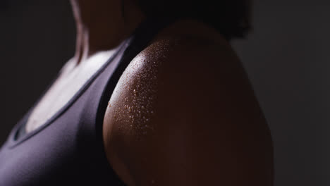 Close-Up-Of-Beads-Of-Sweat-On-Shoulder-Of-Mature-Woman-Wearing-Gym-Fitness-Clothing-Exercising